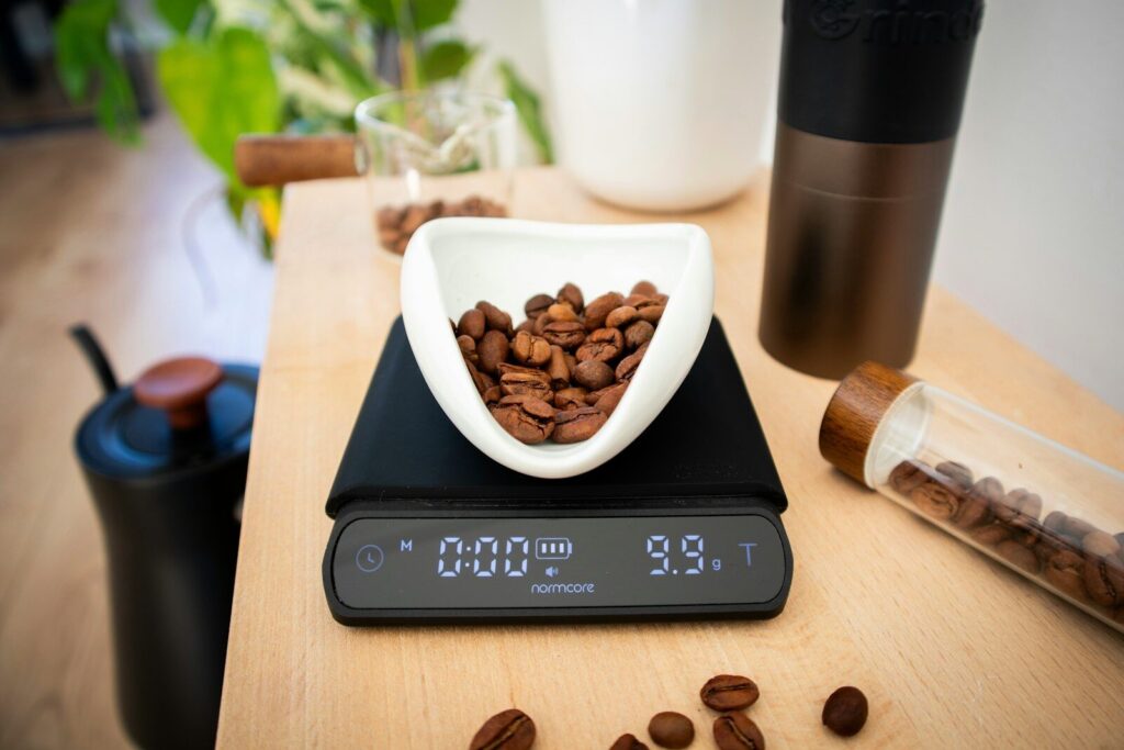 Coffee beans are being weighed on a digital scale.